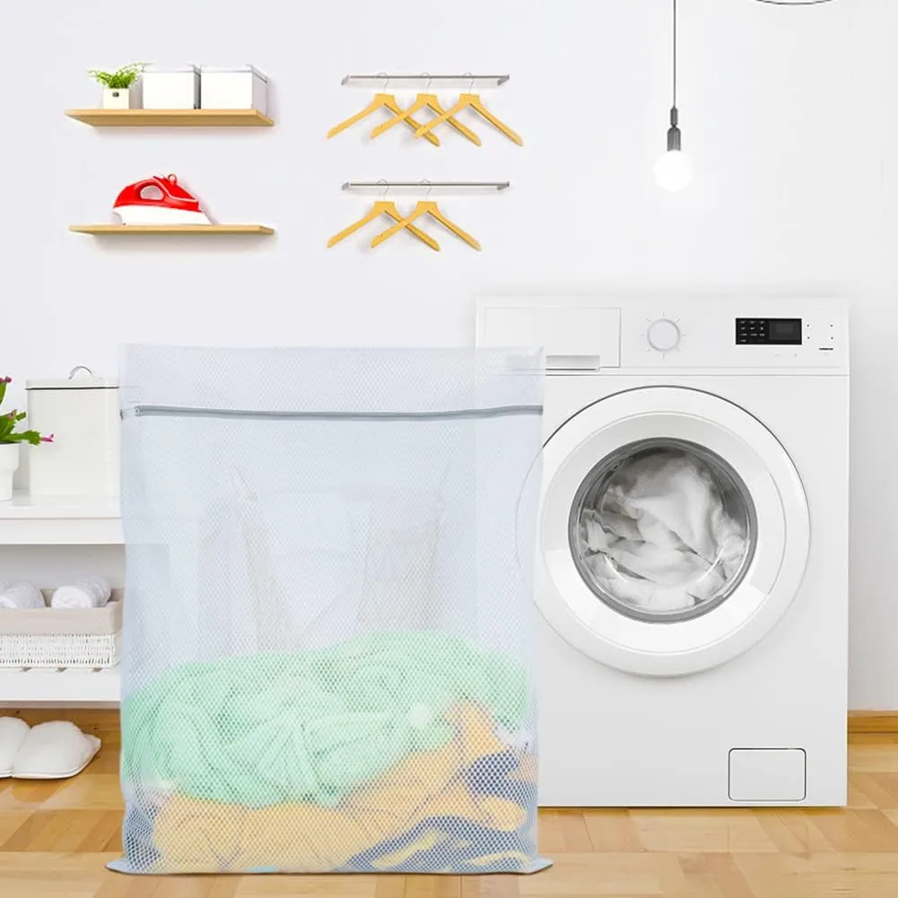 A Vivifying mesh laundry bag full of clothes beside a washing machine