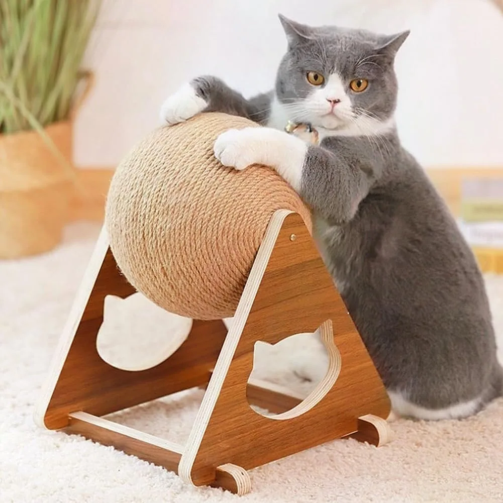 A grey cat gripping a scratching ball wound with Vivifying jute rope